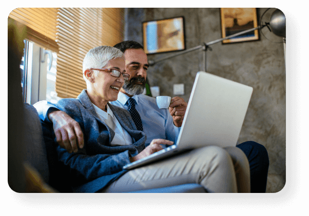 Retired Couple Reviewing Annuities On A Laptop